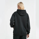 Person wearing a black hoodie from behind on a white background