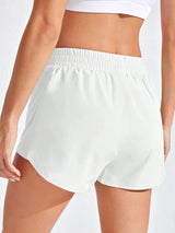 White shorts worn by a person on a white background