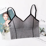 Gray sports bra with black straps on a magazine background
