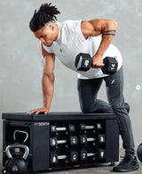 Man lifting dumbbells on a FitBench with weights displayed.