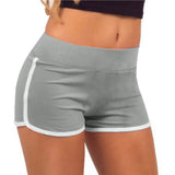 Gray athletic shorts with white trim worn by a person on a white background