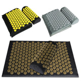 Acupressure mats in black with gold and yellow flower patterns on a white background