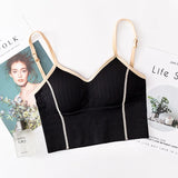 Black ribbed bralette with beige straps on a magazine background