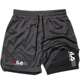Black athletic shorts with FILA logo on a white background