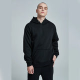 Person wearing a black hoodie against a plain background