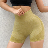 Person wearing yellow athletic shorts against a light gray background