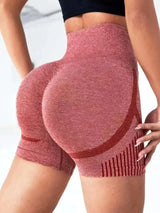 Red high-waisted shorts worn by a person on a light gray background