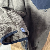 Textured fabric with a visible brand logo on a textured surface