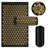 Acupressure mat with gold acupressure nodes and a black cylindrical roller on a white background.