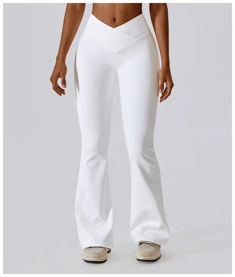 Women’s high-waist flared leggings by Athletic Sanctuary featuring a sculpt and flow performance fit, shown in black on a model.
