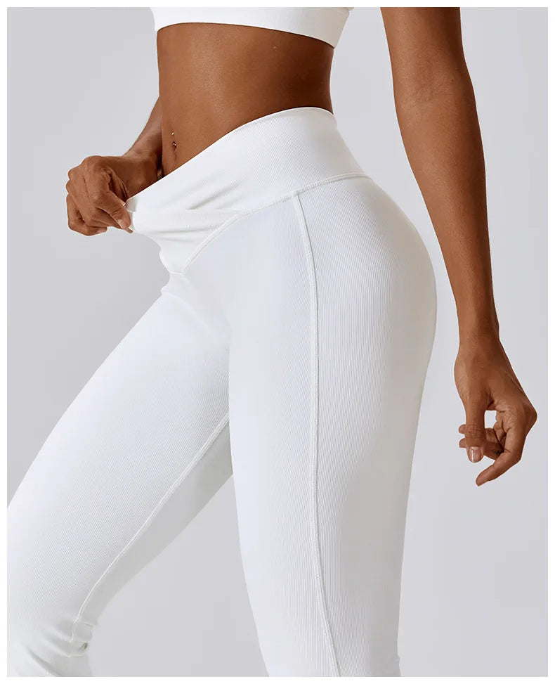 Women’s high-waist flared leggings by Athletic Sanctuary, featuring a sculpting and flowy performance fit, shown on a model.
