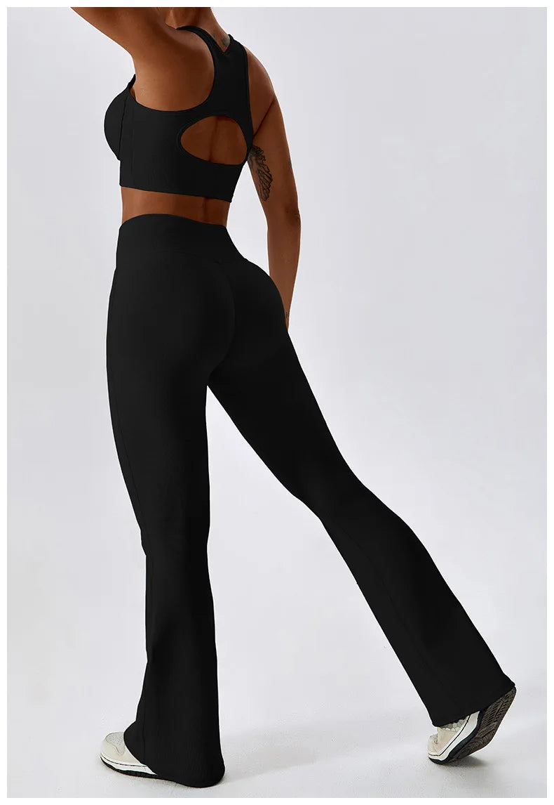Women’s high-waist flared leggings from Athletic Sanctuary featuring a sculpting fit and flowing design, shown in black fabric.