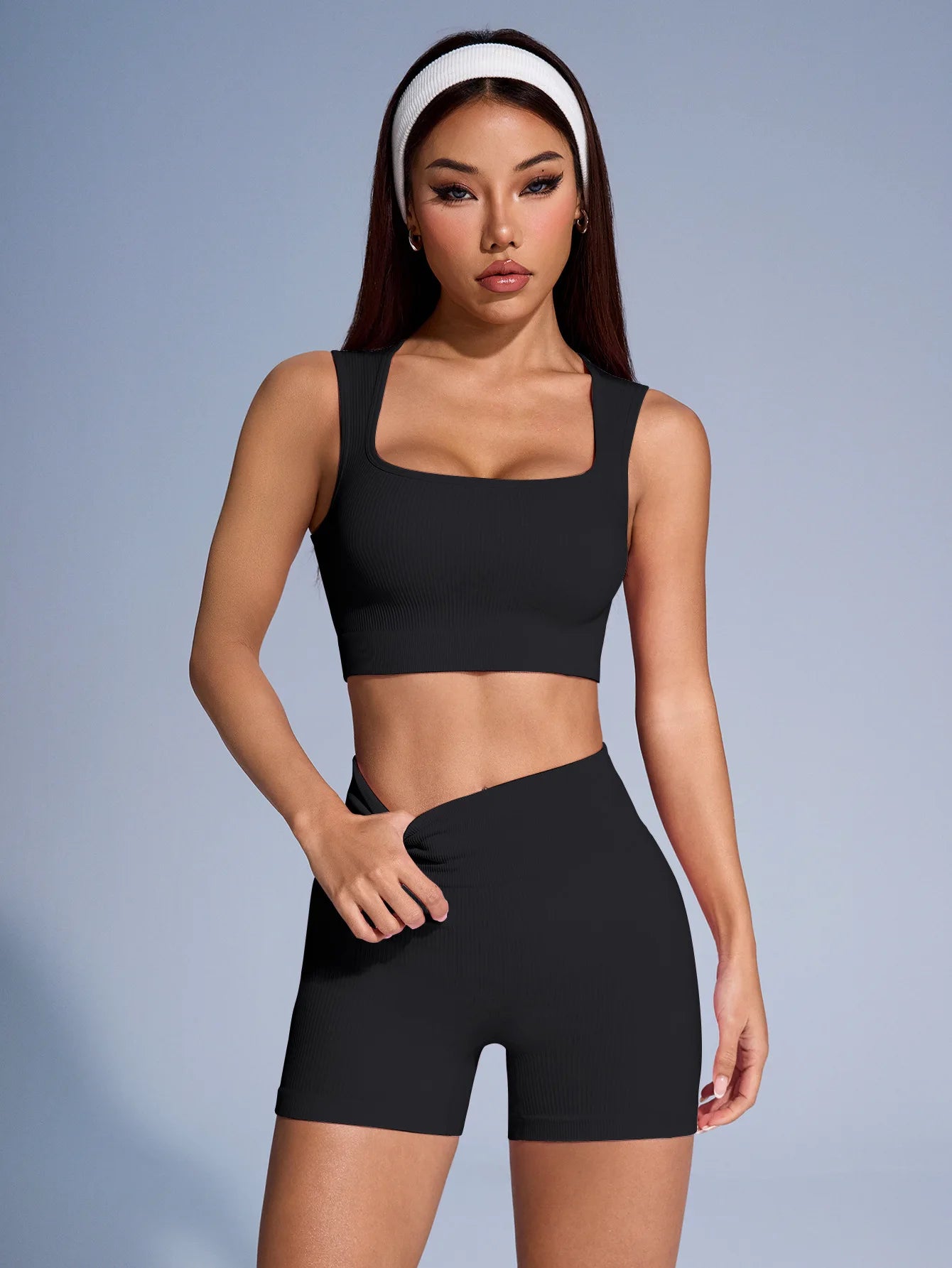 Women’s seamless ribbed workout set with crop tank and shorts from Athletic Sanctuary, shown on a model in active pose.