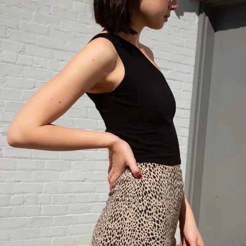 Women’s one-shoulder slim fit sleeveless crop top from Athletic Sanctuary, stylish summer tank in minimalist outfit.