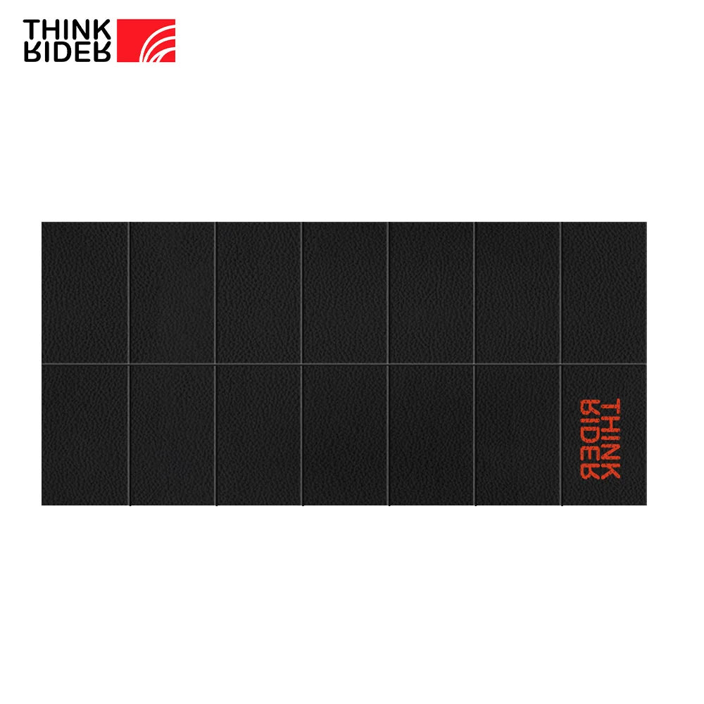 Black ThinkRider Training Mat by Athletic Sanctuary, designed for indoor bike trainers, with branded logo visible on the floor mat.