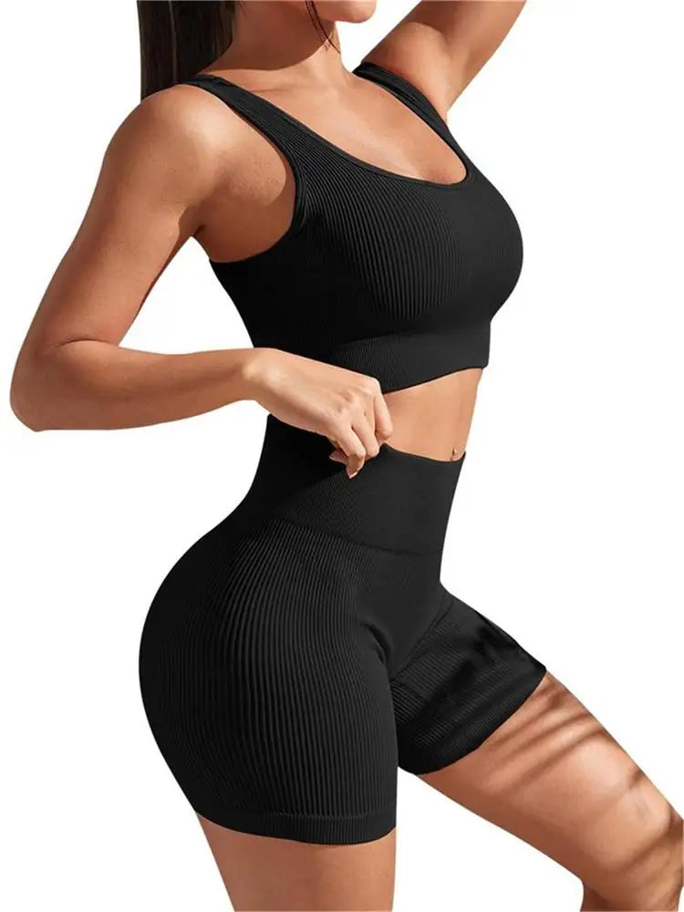 Black women's seamless ribbed workout set with high-waist shorts and crop tank from Athletic Sanctuary, ideal for activewear and fitness.