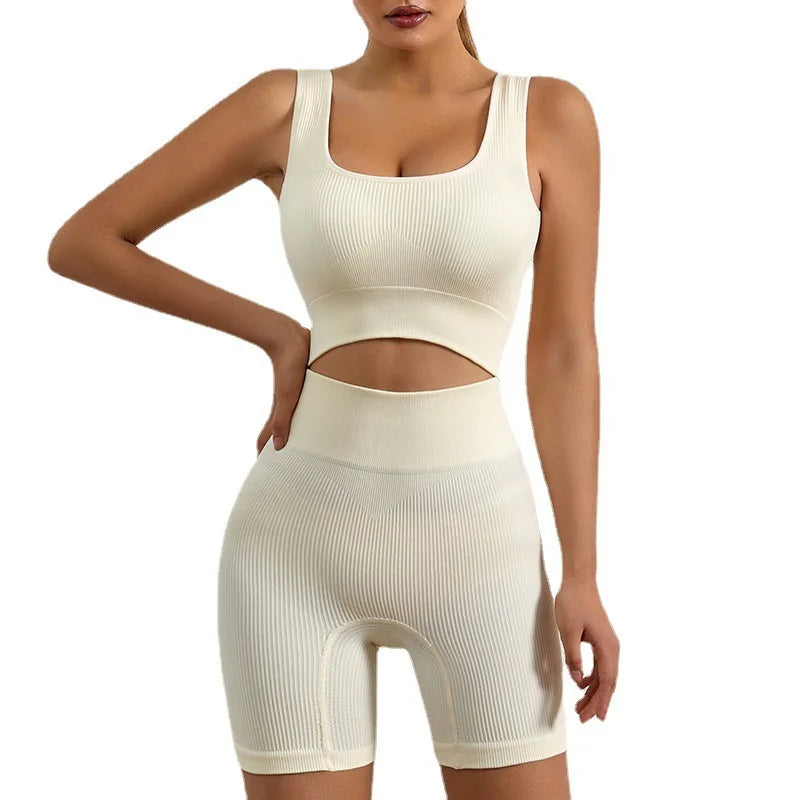 Beige women's seamless ribbed workout set with crop tank and high-waist shorts from Athletic Sanctuary, designed for active wear.