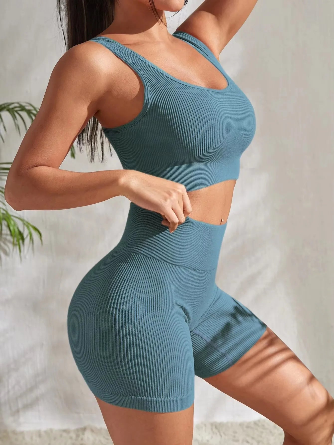 Women’s seamless ribbed workout set with crop tank and high-waist shorts in black, designed for comfort and flexibility.