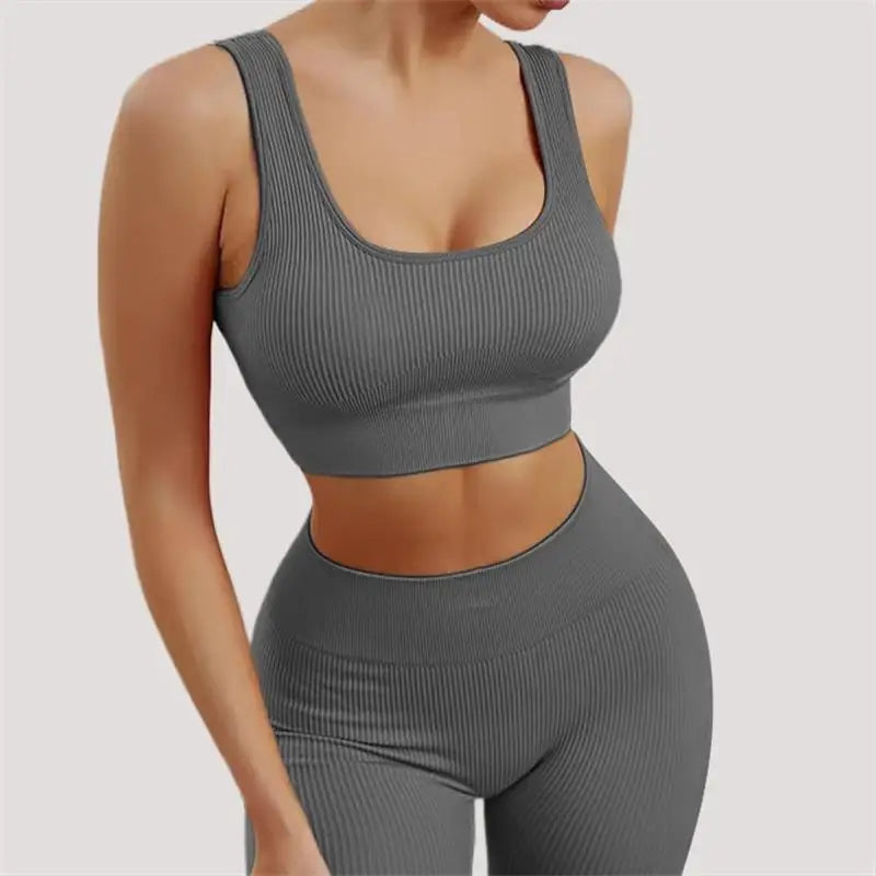 Women's seamless ribbed workout set with crop tank and high-waist shorts by Athletic Sanctuary, shown in black on a model.
