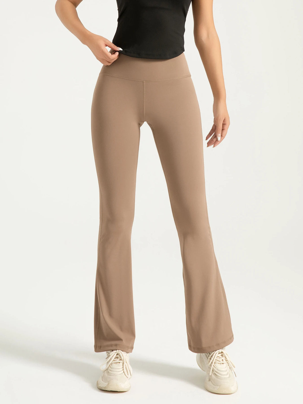 Athletic Sanctuary high-waist flared yoga pants with supportive fit, shown on a model for workout or everyday wear.