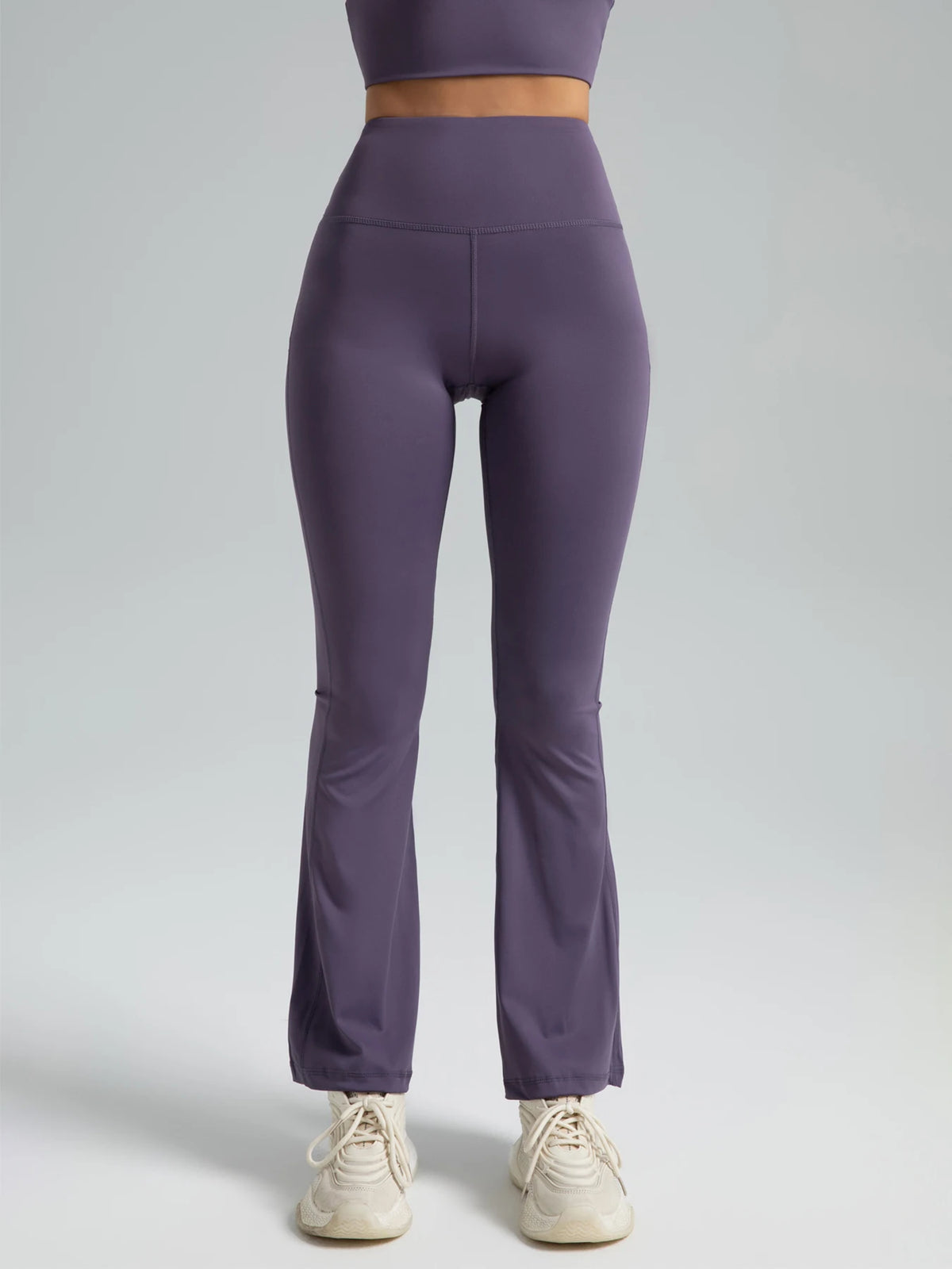 High-waist flared yoga pants by Athletic Sanctuary, showcasing a supportive fit for workouts and casual wear, in a sleek black color.