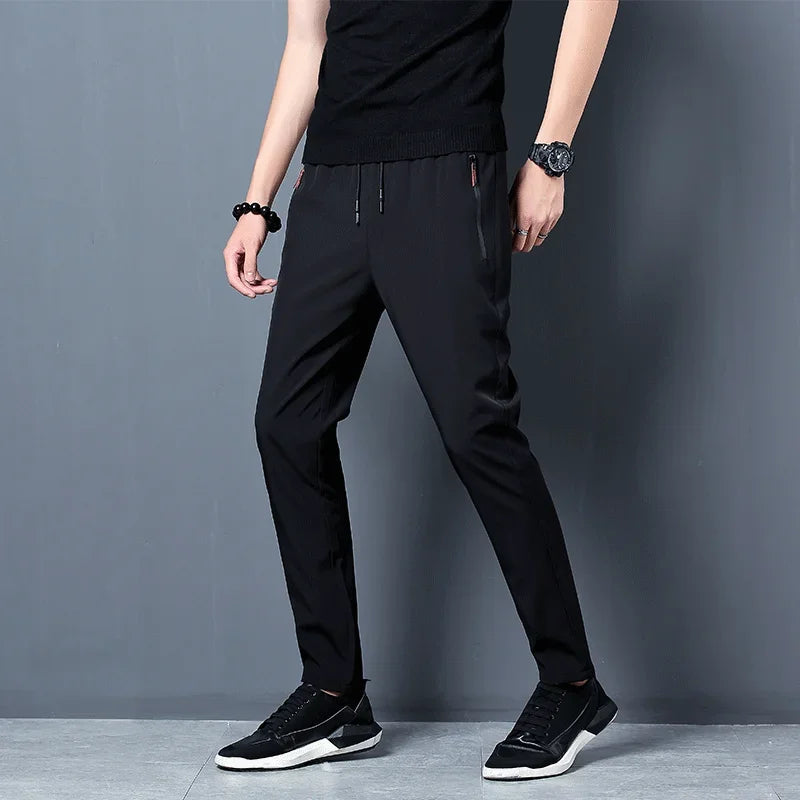 Men’s slim fit casual joggers with straight legs and elastic waist from Athletic Sanctuary, shown in a neutral color.