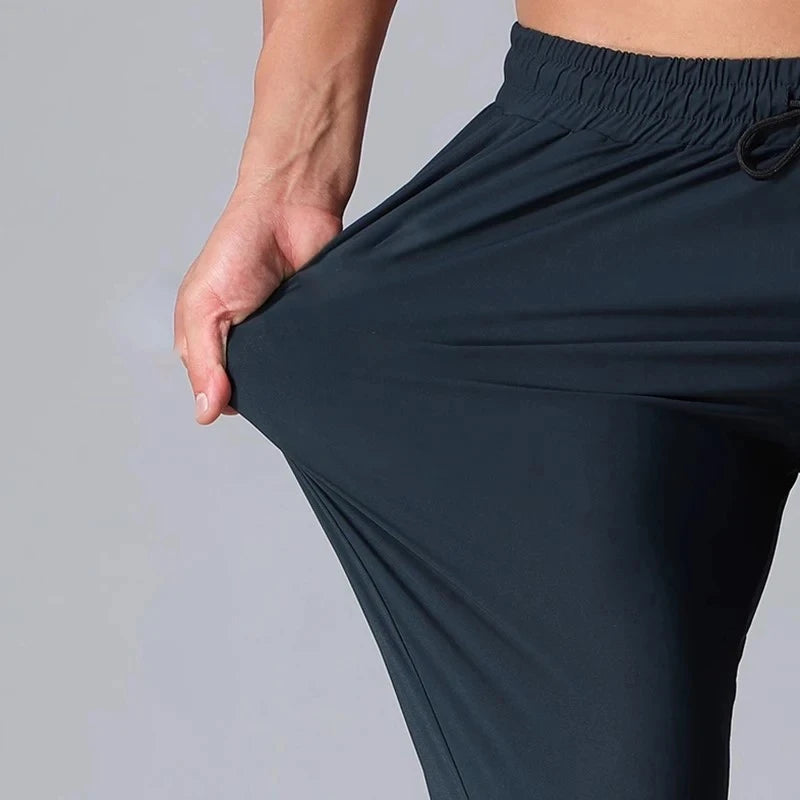 Men’s Athletic Sanctuary streetwear joggers with a relaxed fit, casual gym and track sweatpants, shown in black fabric.