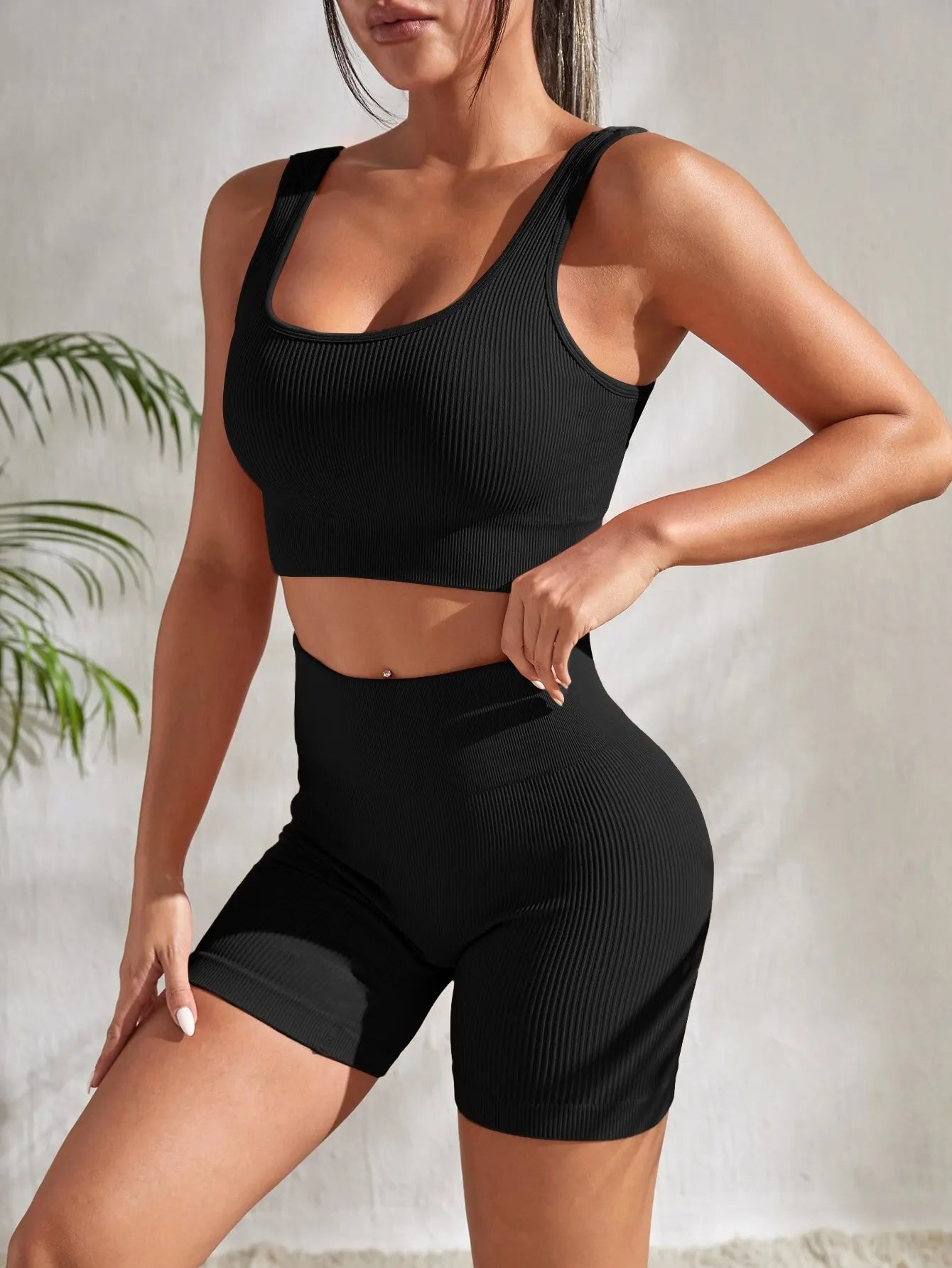 Women’s ribbed seamless gym set with crop tank and high waist shorts from Athletic Sanctuary, shown in black on a model.