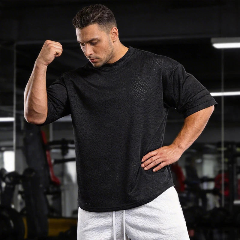 Men’s oversized athletic performance T-shirt by Athletic Sanctuary, quick-dry gym essential, shown in a relaxed fit style.