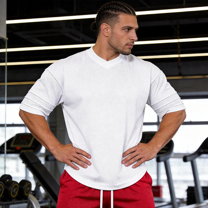 Men’s oversized performance T-shirt by Athletic Sanctuary, quick-dry gym essential, shown in a relaxed fit on a model.