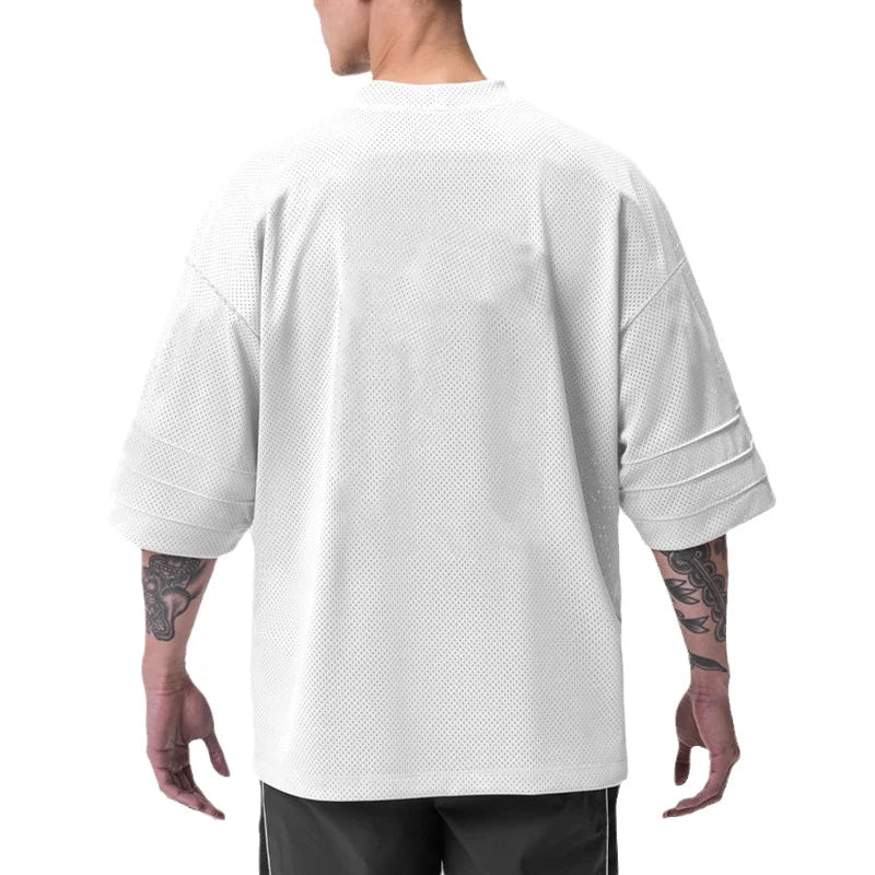 Men’s oversized athletic performance T-shirt by Athletic Sanctuary, quick dry gym essential, black fabric, casual fit, front view.