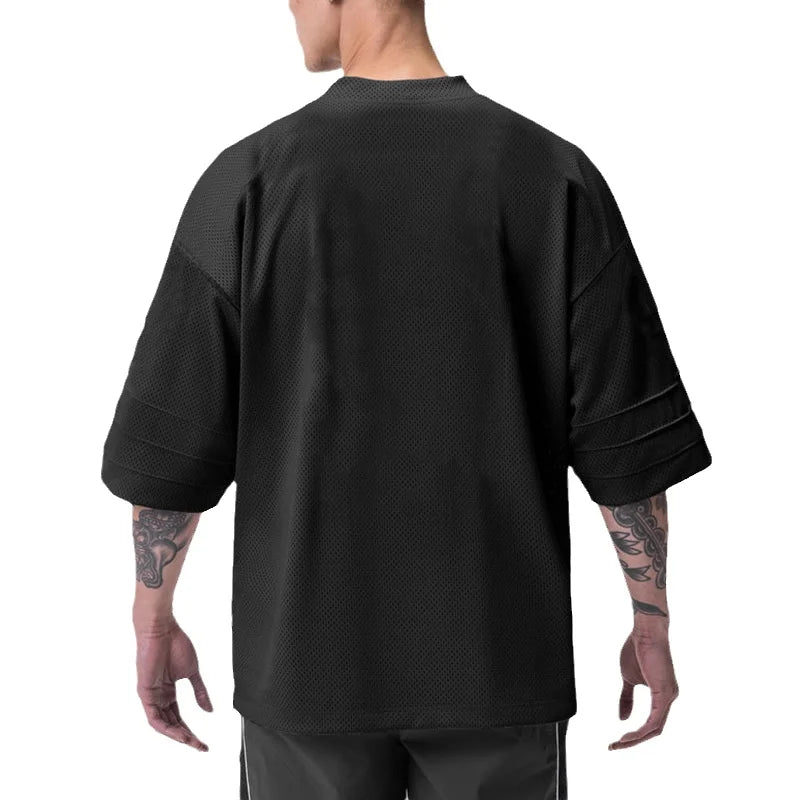 Men’s oversized performance T-shirt by Athletic Sanctuary, quick-dry gym essential, shown in a relaxed fit design with lightweight fabric.