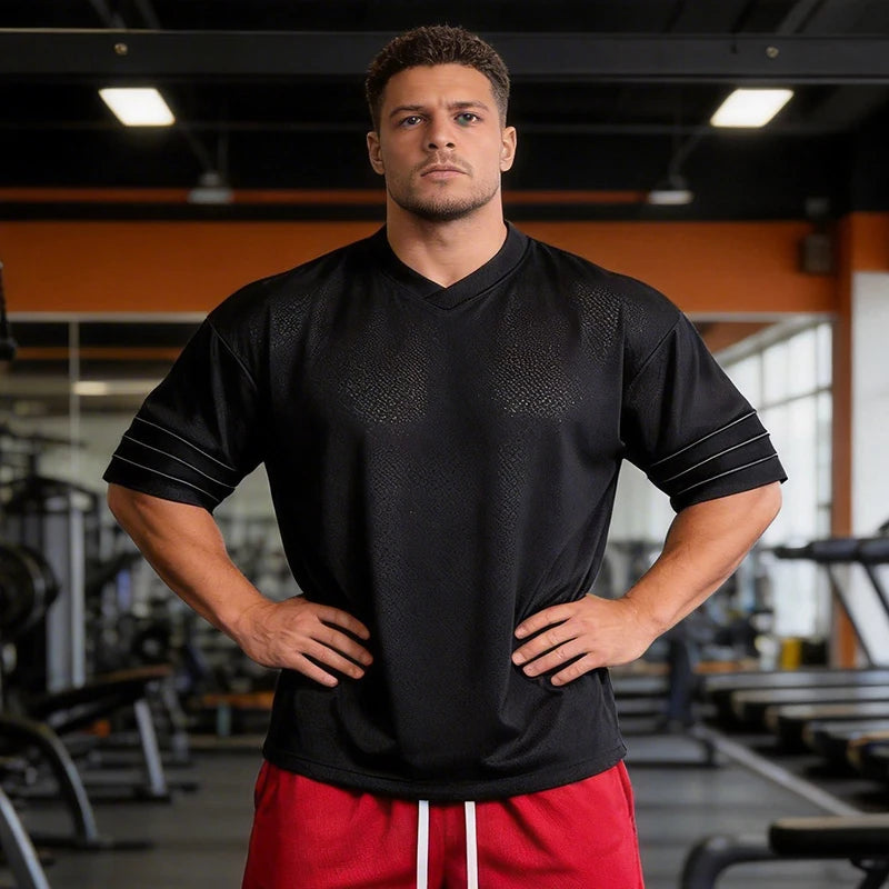 Men’s oversized Athletic Sanctuary performance T-shirt, quick dry gym essential, shown in a comfortable fit with breathable fabric.