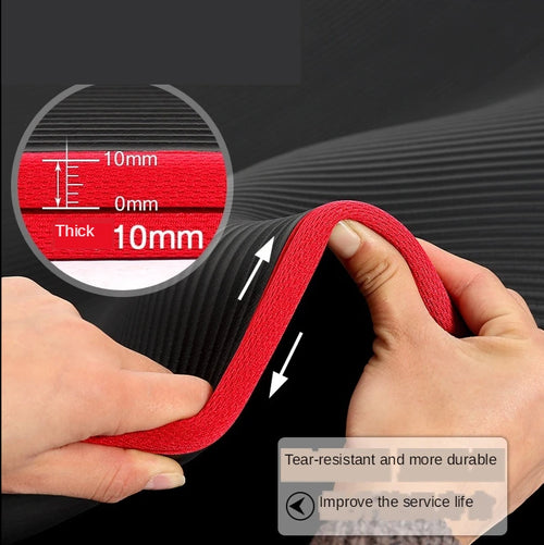 Close-up of red Athletic Sanctuary 10mm thick yoga mat being stretched, showing its extra thickness and non-slip surface for workouts.