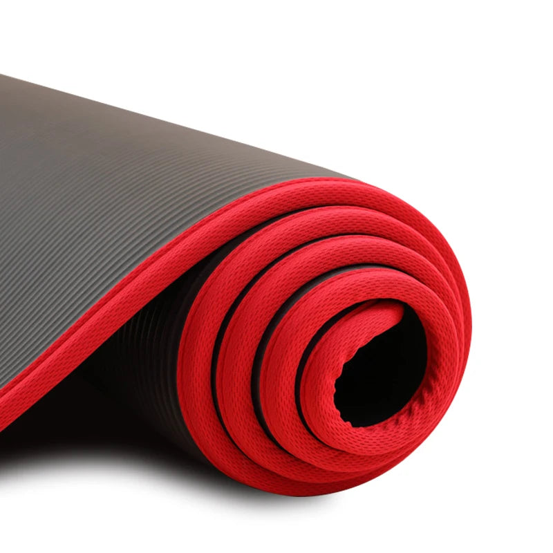 Athletic Sanctuary 10mm thick yoga mat with non-slip surface for Pilates and workout exercises, shown rolled out on a wooden floor
