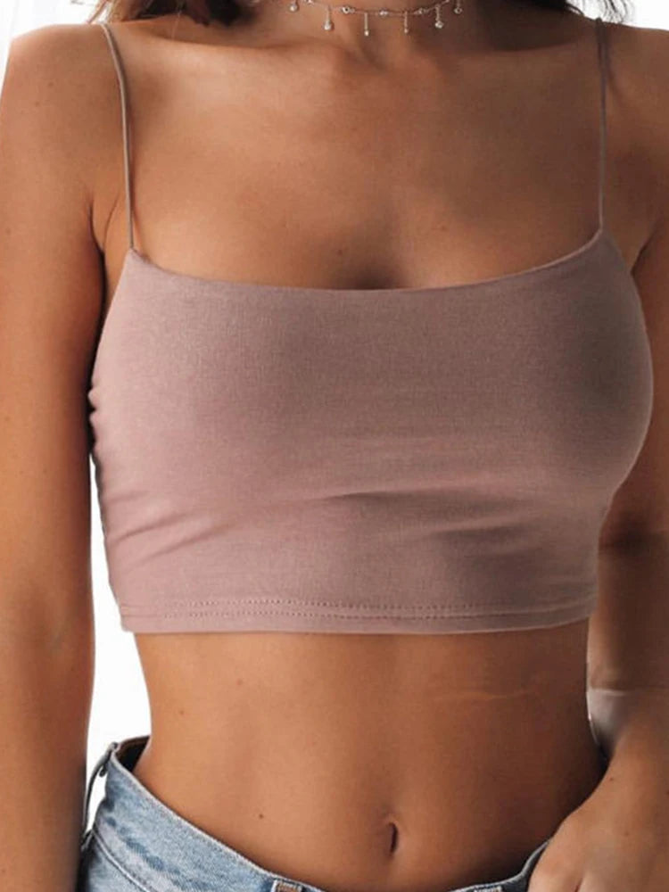 Slim-fit, sleeveless pink sheer crop tank top from Athletic Sanctuary paired with jeans, backless and perfect for summer.