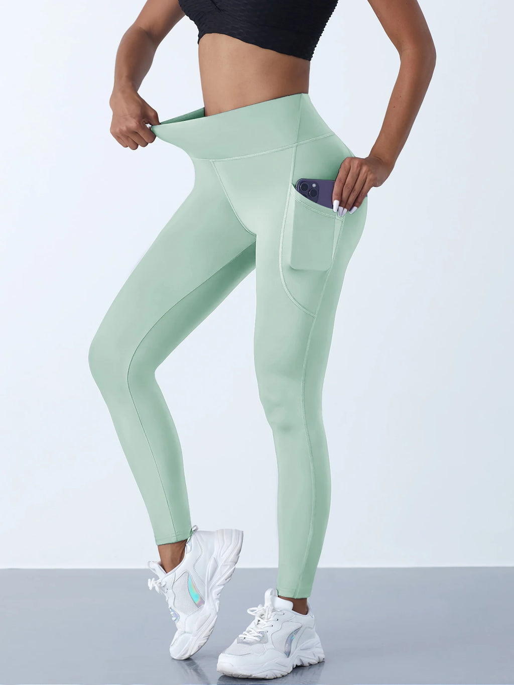Women’s high-waist performance leggings by Athletic Sanctuary with stretch fit and functional pockets, shown on a model.