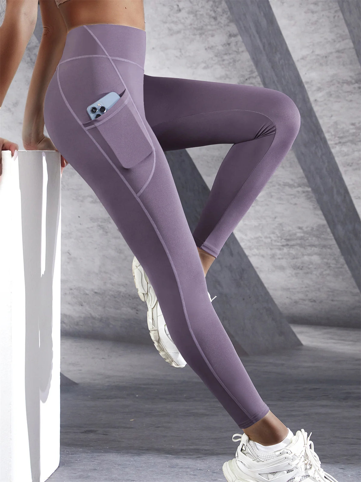 Women’s high-waist performance leggings by Athletic Sanctuary with stretch fit and side pockets, shown on a model.