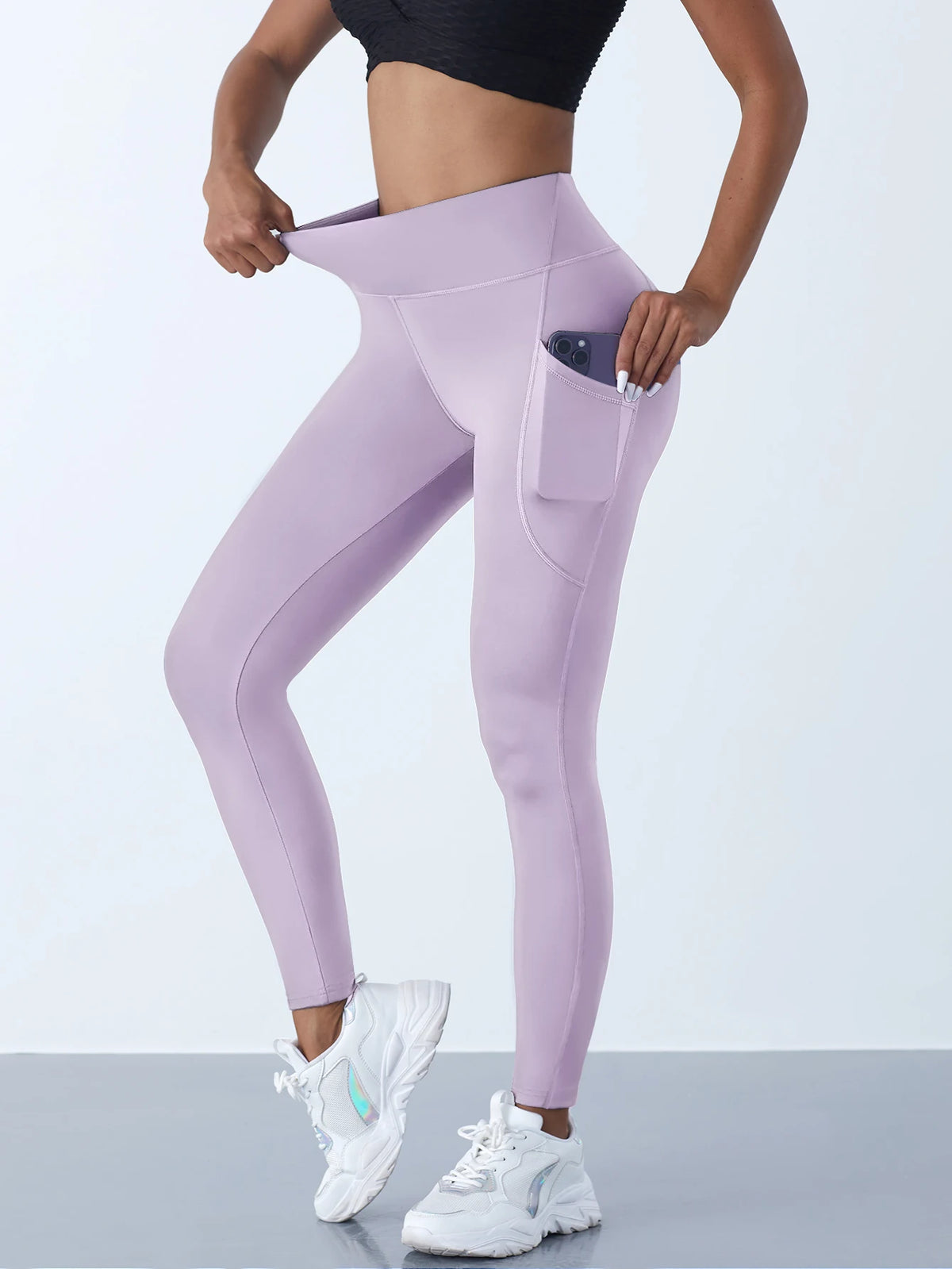 Women’s high-waist performance leggings by Athletic Sanctuary with stretch fit and side pockets, shown on a model.