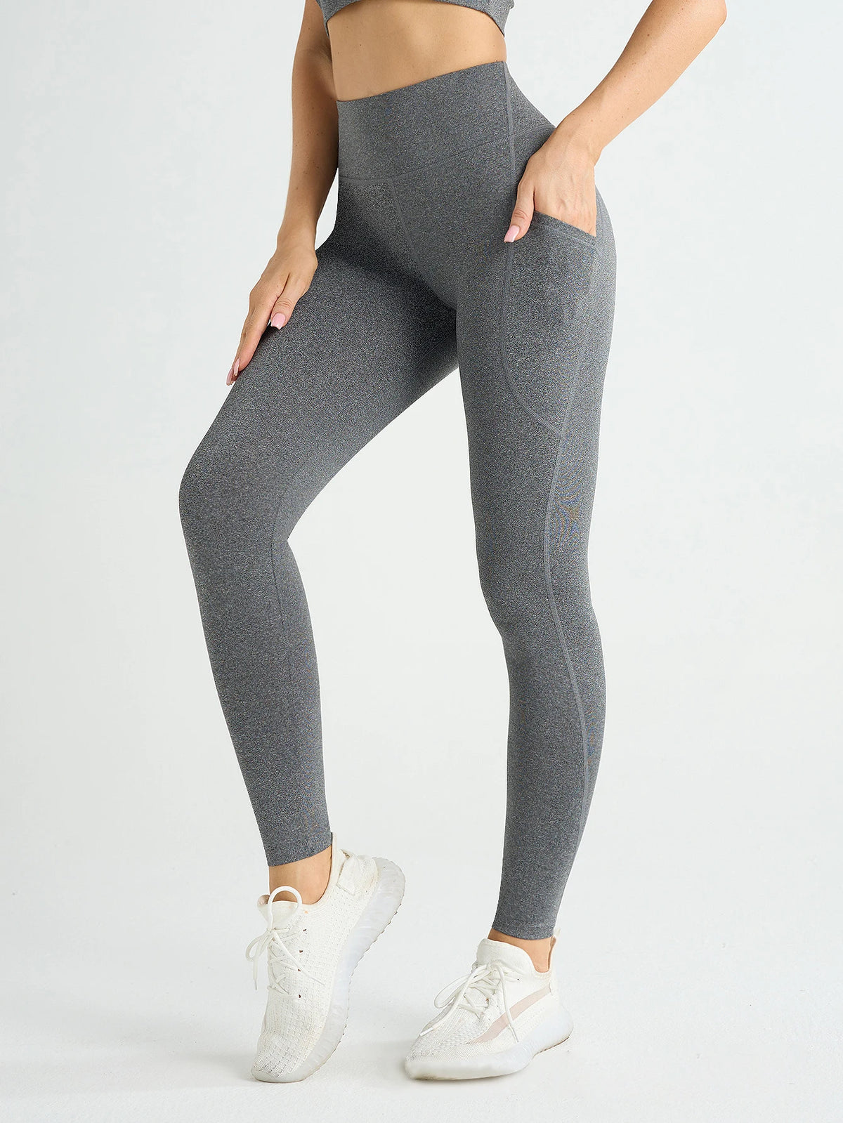 Women’s high-waist athletic leggings with stretch fit and side pockets, from Athletic Sanctuary, shown on a model.