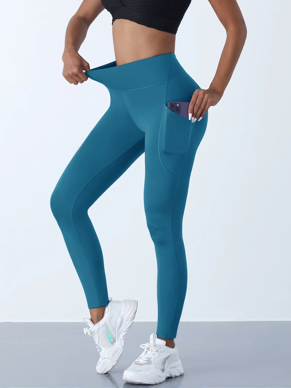 Women’s high-waist performance leggings by Athletic Sanctuary with stretch fit and side pockets, shown on a model.